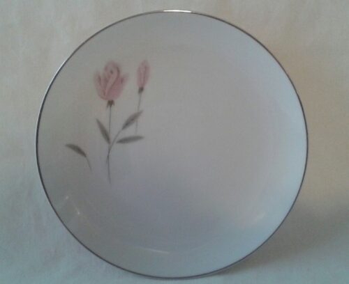 A white plate with pink flowers on it.
