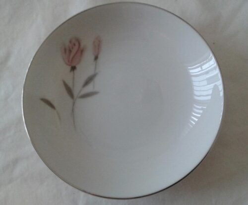 A white plate with pink flower on it