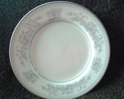 A white plate with some gray flowers on it