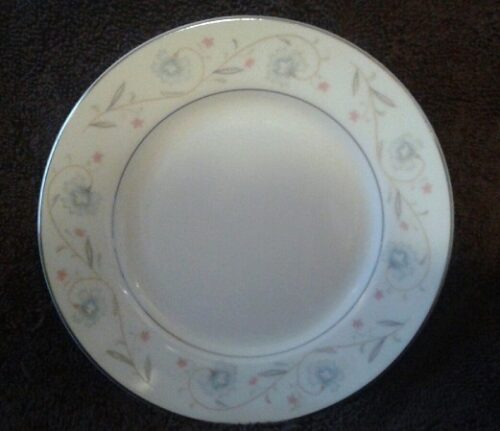 A white plate with blue and pink flowers on it.