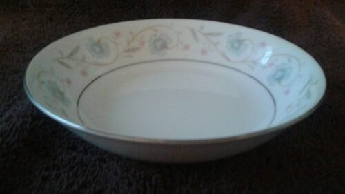 A bowl with flowers on it sitting on the table.
