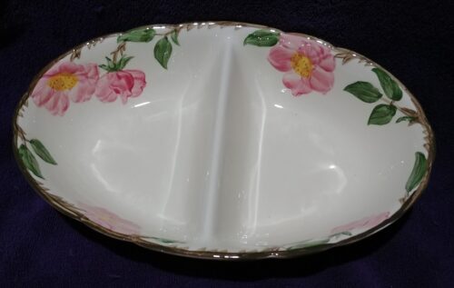 A white bowl with pink flowers on it