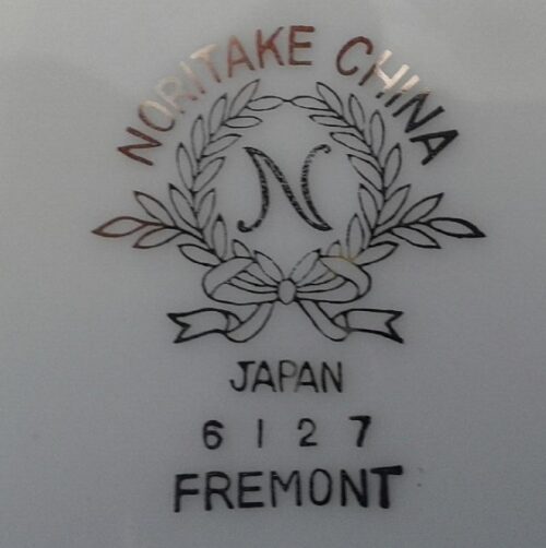 A close up of the name and date on a plate.