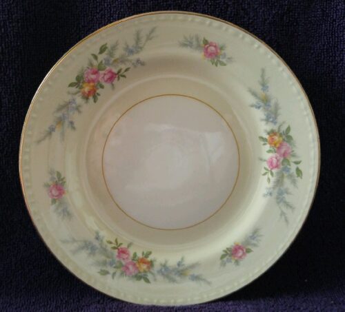 A plate with flowers on it is sitting on the table.