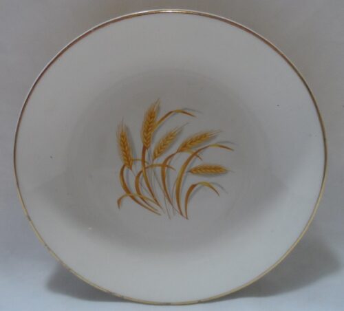 A white plate with gold wheat on it.