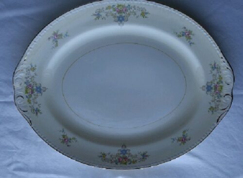 A white plate with blue and yellow flowers on it.