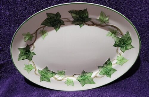 A white plate with green leaves on it
