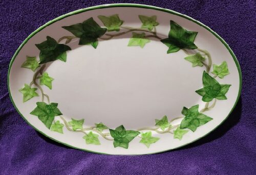 A white plate with green ivy on it
