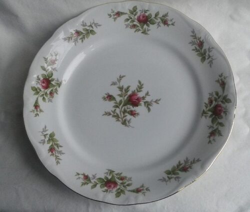 A white plate with red flowers on it