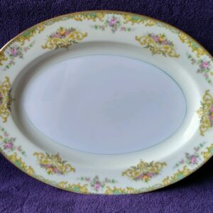 A white plate with yellow and pink flowers on it.