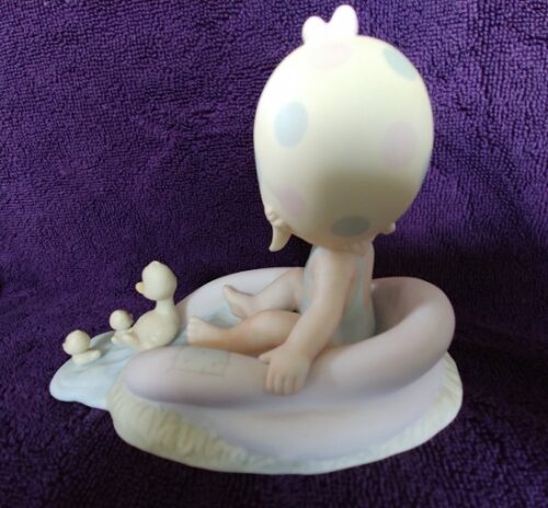 A figurine of a baby in the bathtub