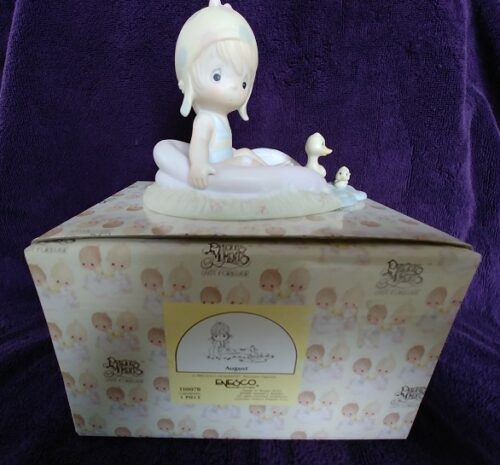 A box with a figurine sitting in the middle of it