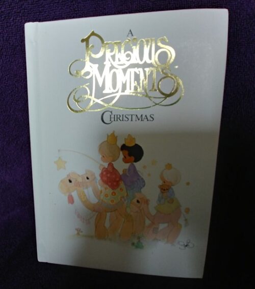 A christmas book is shown in front of purple background.