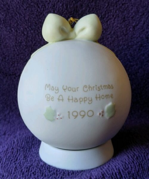 A white ornament with a bow on it.
