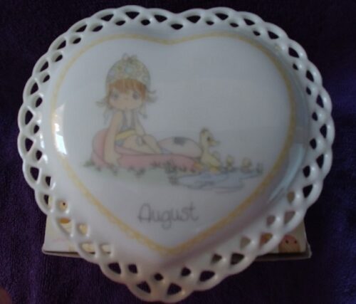 A heart shaped plate with a picture of a girl on it.