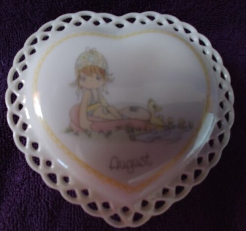 A heart shaped dish with a picture of a girl and her dog.