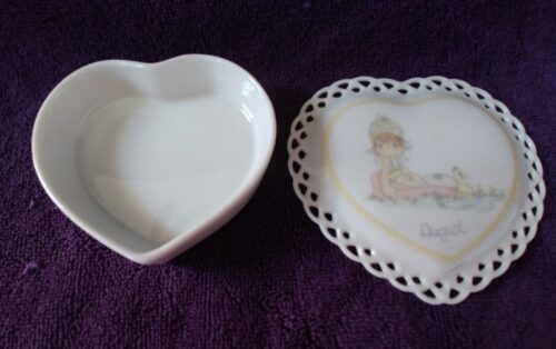 A heart shaped dish and a small plate with a picture of a girl.
