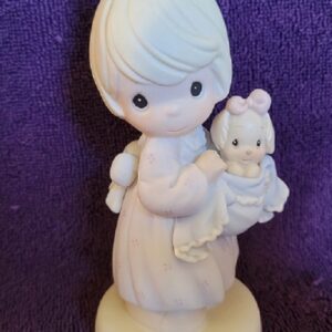A figurine of a woman holding a baby.