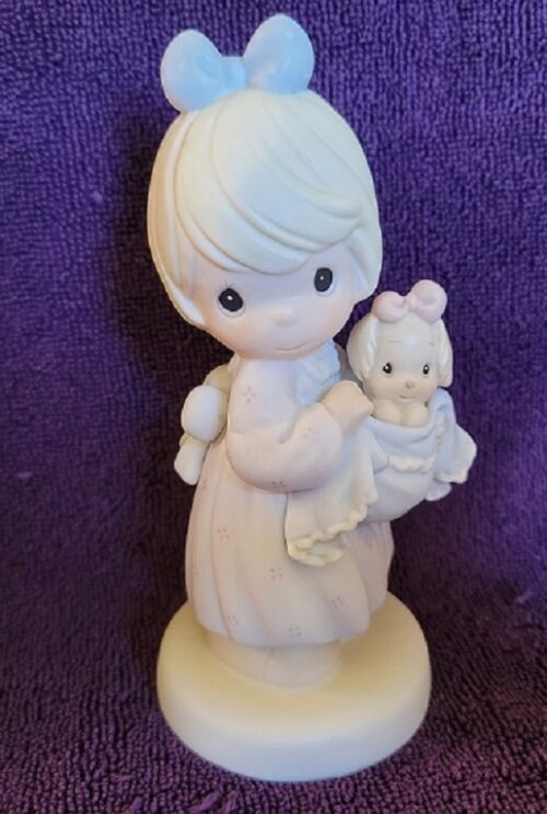 A figurine of a woman holding a baby.
