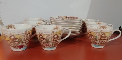 A table with cups and plates on it