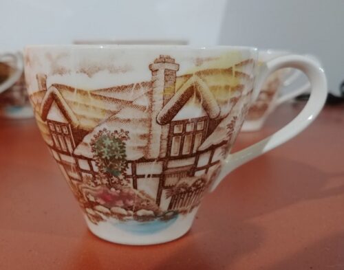 A cup with a picture of houses on it
