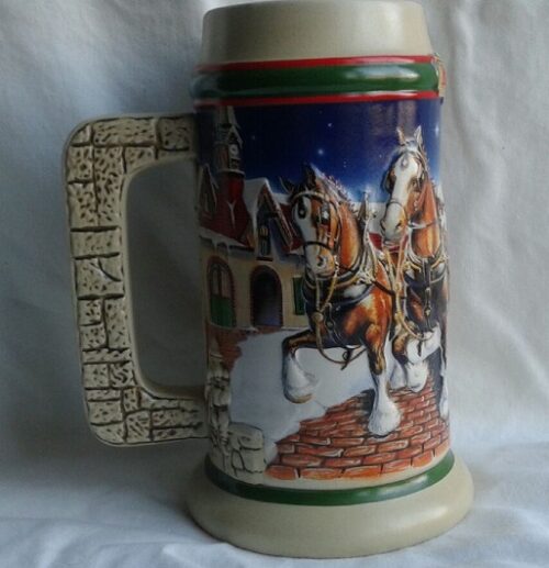 A beer mug with a picture of horses and riders.