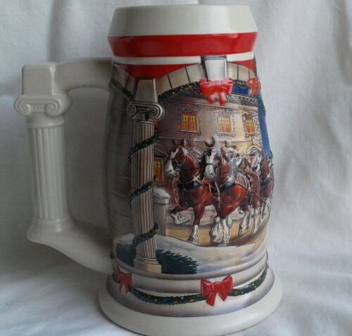 A beer mug with a picture of horses and riders.