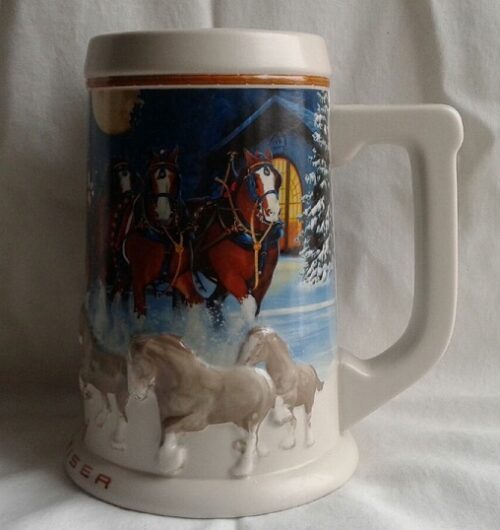 A beer mug with horses and riders on it.