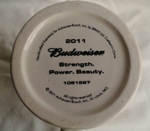 A white plate with the words " budweiser strength, power and beauty ".