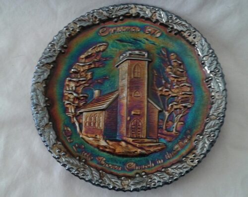 A decorative plate with a church on it.