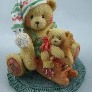 A teddy bear sitting on top of another teddy bear.