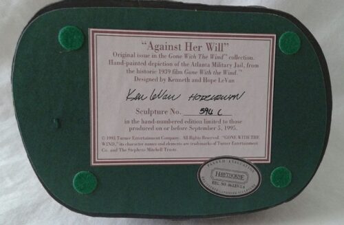 A plaque with the words " against her will ".