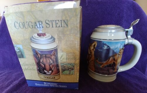 A beer stein with an animal picture on it.