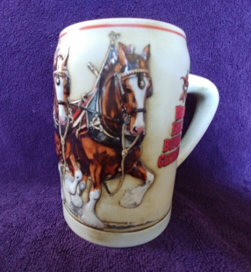 A mug with two horses pulling a carriage.