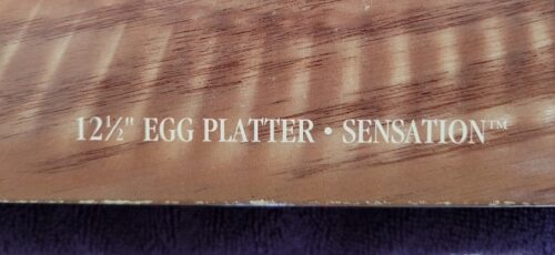 A wooden box with the words " egg platter sensations ".