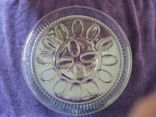 A glass plate with a flower design on it.