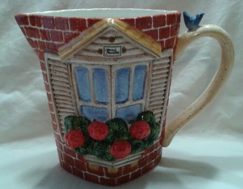 A cup with a window and flowers on it