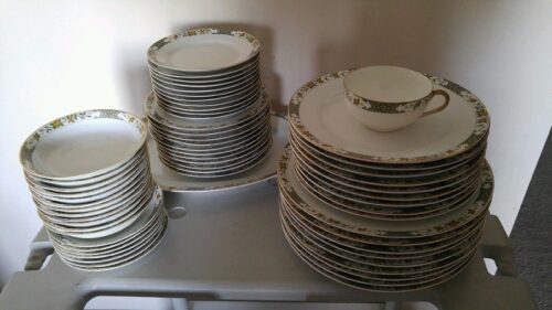 A table with plates and bowls stacked on top of each other.