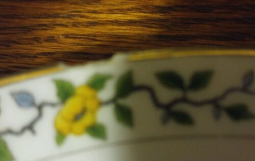 A close up of the yellow flower on a bowl
