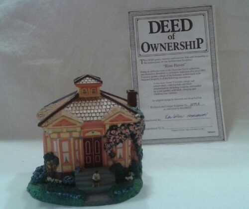 A miniature house with a deed of ownership attached.
