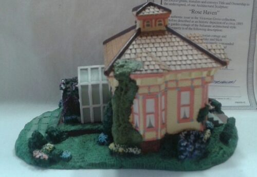 A small house with a garden and a tree