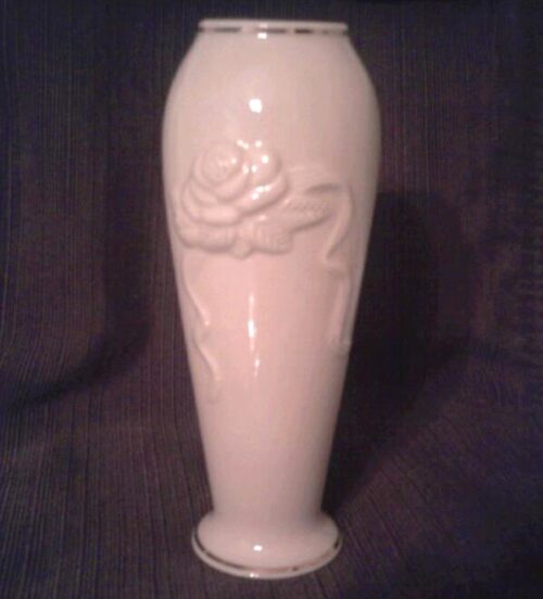 A white vase with a rose design on it.