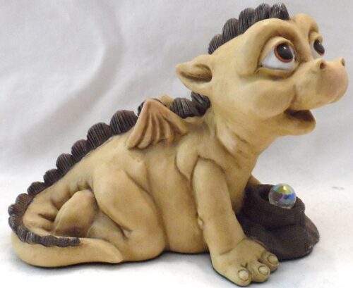 A dragon figurine sitting on top of a table.