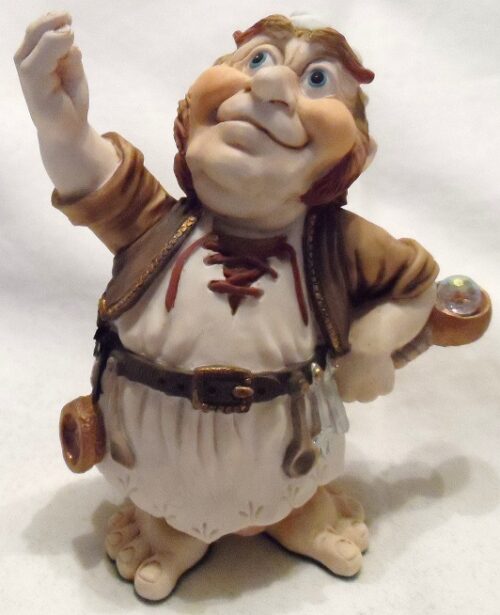A ceramic figurine of a man in brown and white clothing.