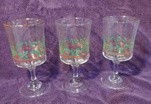 Three wine glasses with a design on them.