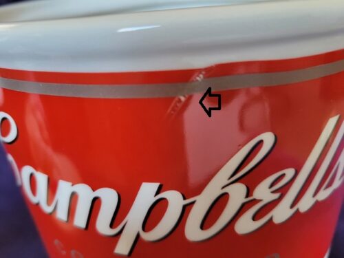 A close up of the lid on a campbell soup can.