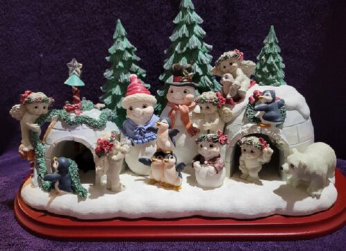 A group of figurines are sitting on the snow.