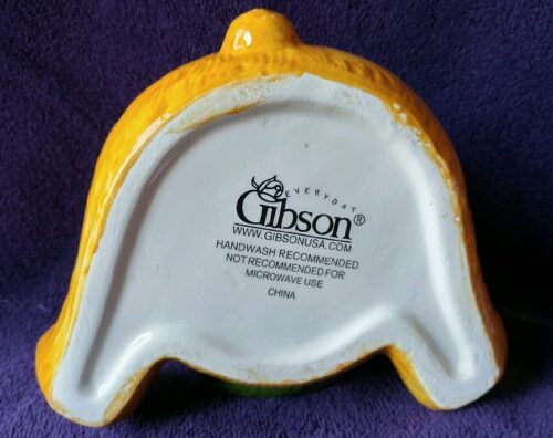 A yellow and white dish with the gibson logo on it.