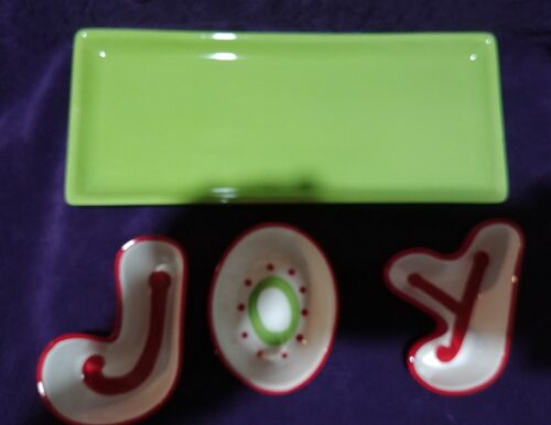 A green tray and some red letters on the table