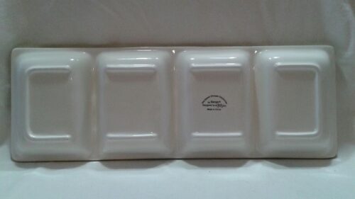 A white tray with four sections on top of it.
